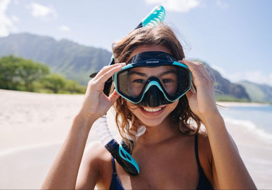 A girl situates her snorkel before entering the ocean